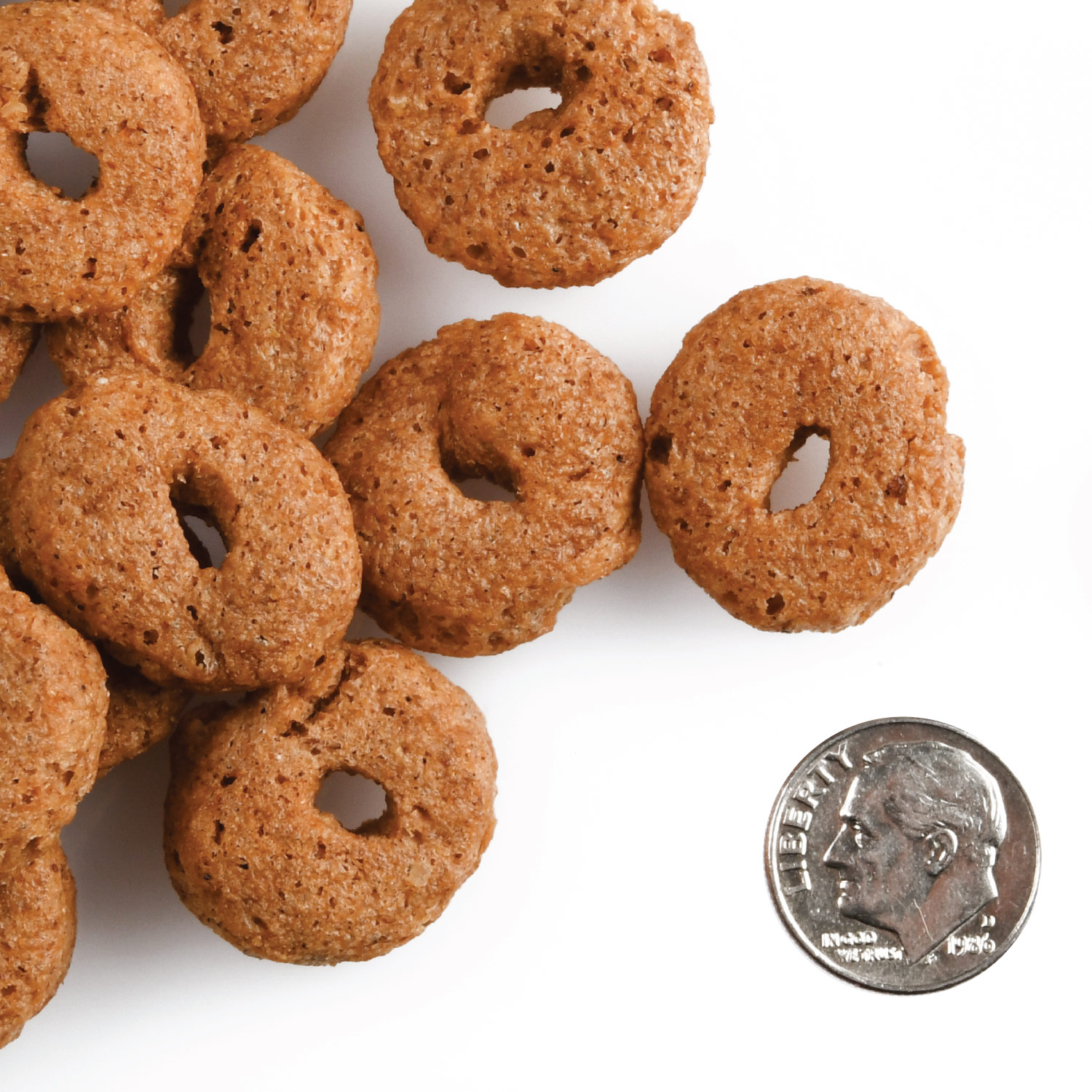 A small pile of Crunchy Os Banana Kablammas treats next to a dime for scale.
