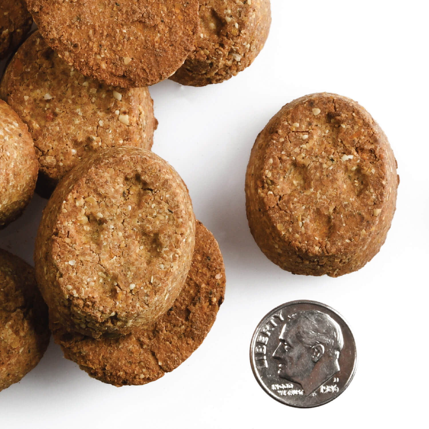 A small pile of Four-Star Parmesan Cheese treats next to a dime for scale.