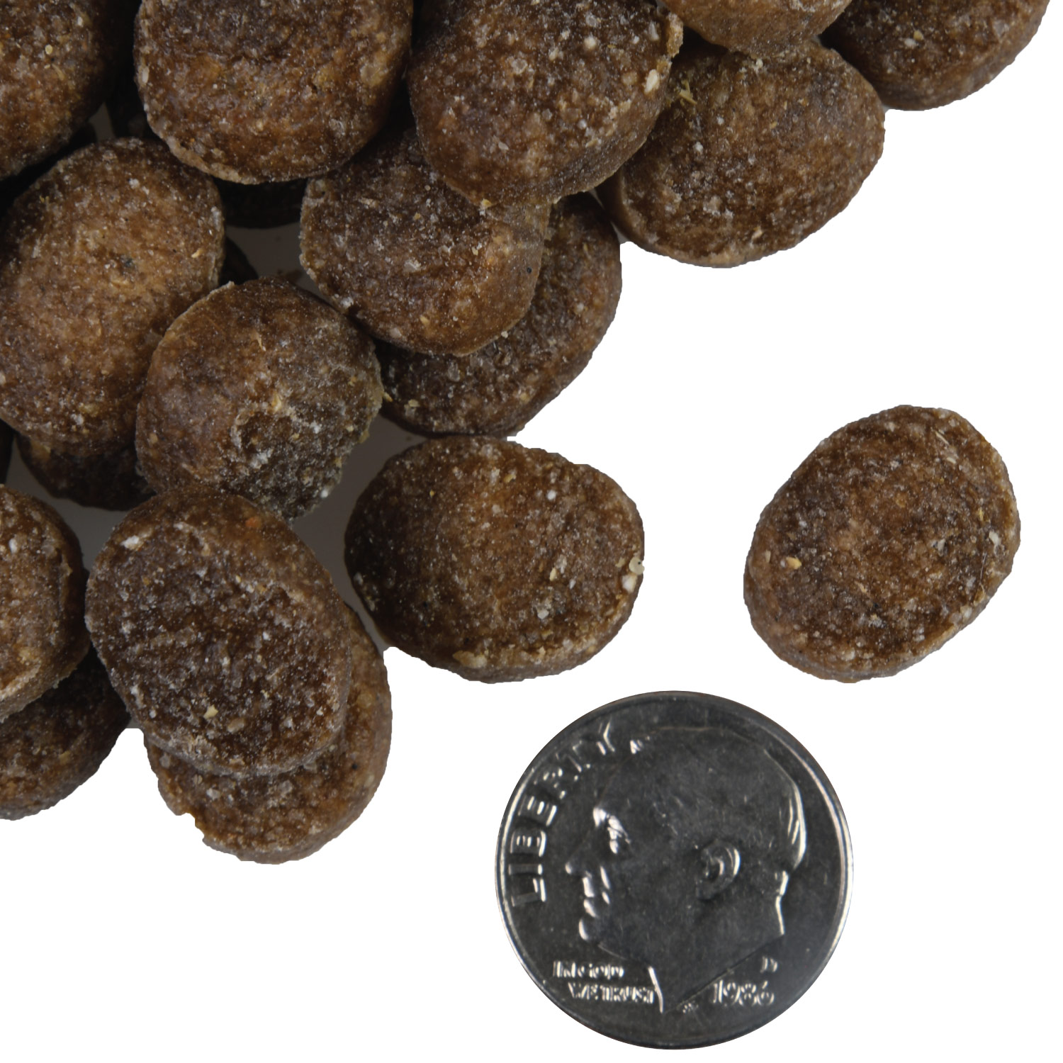 A small pile of Tenderollies Beef-a-Rollie Flavor Dog treats next to a dime for scale.